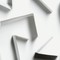 Abstract white paper shapes creating a modern geometric design with shadows.
